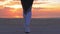 Closeup of athletic woman`s feet walking on the beach