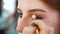 Closeup attractive young woman getting professional makeup at beauty salon