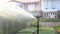Closeup of automatic sprinkler systems, drip irrigation, watering lawns and garden in sunny weather