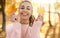 Closeup autumn sunlight portrait smiling woman holding maple leaves at sunny autumn park.