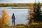 Closeup of autumn tundra foliage with reds and golds, fairytale scenery. Woman in bokeh on the foreground