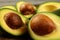 Closeup on avocado halves, detail on the seed and pulp.