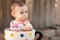 Closeup of baby girl in giant teacup