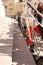 Closeup of baby strollers lined up outdoors near sideway