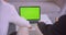 Closeup back view portrait of two businessmen using laptop with green chroma screen and celebrating success in the