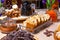 Closeup bakery and snacks, dried fruits and nuts in glass bowls, cinnamon, plate with raisin biscotti. Concept degustation luxury