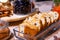 Closeup bakery and snacks, dried fruits and nuts in glass bowls, cinnamon, plate with raisin biscotti. Concept degustation luxury