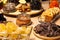Closeup bakery and snacks, dried fruits, pieces parmesan cheese, honeycombs, dark chocolate, cinnamon sticks, raisin biscotti.