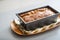 Closeup on baking dish with bread on table