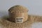 Closeup of banyard millet, a healthy grain, in a glass bowl with label on it filled to the brim