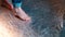 Closeup of bare feet of children in a dance studio.