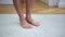 Closeup of bare feet of man scratching his feet