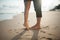 Closeup barefoot couple legs at the beach