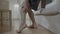 Closeup of barefoot senior man having muscle discomfort on leg while he standing up from couch -