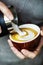 Closeup of barista making latte art coffee drink