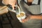 Closeup of barmen pouring milk to cappuccino cup