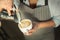 Closeup of barmen pouring milk to cappuccino cup