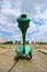 Closeup of a barrel of an old green cannon. Wide angle