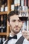 Closeup Of Bartender Examining Red Wine