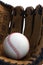 Closeup of baseball glove holding baseball