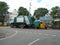 Closeup of BBMP garbage collecting lorry and auto parking on roadside