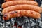 Closeup BBQ with fiery sausages on the grill