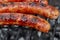 Closeup BBQ with fiery sausages on the grill