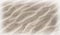 Closeup beach wavy sand background with light fading to white bo