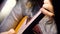 Closeup beautiful acoustic guitar being played by woman sitting down, musician concept. Woman playing the guitar closeup