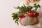 Closeup of beautiful autumn composition in a pumpkin vase in woman`s hands. Flower and red berries arrangement