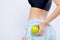 Closeup beautiful body woman sexy slim holding green apple with cellulite for wellness, girl waist thin with fitness