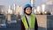 Closeup beautiful engineer woman smiling cute in front of the camera after she take off the protective mask from face