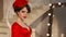 Closeup of beautiful fashion young girl in retro hat and red dress, brunette model with red lips makeup, elegant