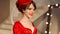 Closeup of beautiful fashion young girl in retro hat and red dress, brunette model with red lips makeup, elegant