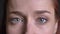 Closeup of beautiful female gray eyes looking straight at camera and then closing