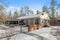 Closeup of a beautiful modern ranch house in the forest surrounded by snow