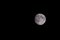 Closeup of beautiful silver full moon over dark black sky