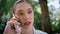 Closeup beautiful woman calling by mobile phone on nature. Serious lady speaking