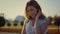 Closeup beautiful woman holding ladies sunhat in hands in summer garden outdoor.