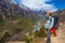 Closeup Beautiful Woman Traveler Backpacker Mountains Path.Young Girl Looks Horizon Take Rest.North Summer Snow