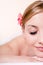 Closeup on beautiful young blond woman in spa treatments happy smiling eyes closed on white background