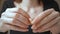 Closeup of beautiful young woman peels boiled shrimp