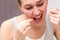 Closeup of beautiful young woman using dental floss for healthcare