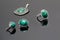 Closeup beauty silver earrings, ring and pendant with malachite on black acrylic desk