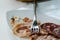 Closeup of a bee on meat slices on a plate under the lights