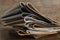 Closeup of beige colored pieces of leather on the wooden desk against brick wall.Samples of leather for furniture