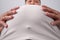 Closeup belly of an Asian fat man wearing a gray shirt