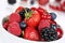 Closeup berry fruits in bowl with strawberries, blueberries and