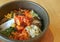 Closeup Bibimbap or Korean Traditional Mixed Rice with Meat and Assorted Vegetables in Hot Stone Bowl