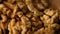 Closeup of big shelled walnuts pile rotating, macro